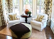 Thumbnail 5 of 7 - a living room with two chairs and a ottoman in front of a window