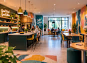 Thumbnail 6 of 6 - A restaurant with a green sign that says "Good Food Good Vibe" on the wall.