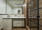 Thumbnail 6 of 10 - A bathroom with a white countertop and a white sink.