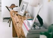 Thumbnail 2 of 2 - A white dresser with a lamp and a picture frame on top of it.