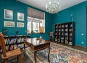 Thumbnail 2 of 21 - A room with a wooden table and a chandelier.