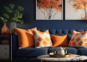 Thumbnail 4 of 10 - A living room with a blue couch and orange pillows.