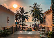Thumbnail 4 of 5 - A sunset view from a balcony overlooking the ocean.