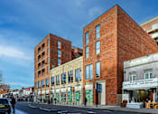 Thumbnail 6 of 8 - a large brick building on a city street