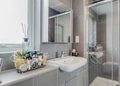 Thumbnail 4 of 7 - a bathroom with a sink and a shower