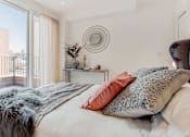Thumbnail 6 of 7 - a bedroom with a bed and a large window