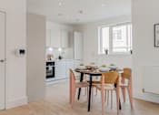 Thumbnail 7 of 7 - a kitchen and dining area with a table and chairs