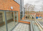 Thumbnail 10 of 10 - a balcony with a brick wall and glass doors