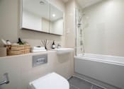 Thumbnail 6 of 6 - a white bathroom with a shower and a sink and a toilet