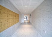 Thumbnail 4 of 6 - a long hallway with rows of lockers in a building