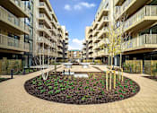 Thumbnail 2 of 6 - a courtyard with a fountain in the middle of an apartment building