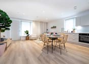 Thumbnail 3 of 6 - a kitchen and dining room with a table and chairs