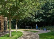 Thumbnail 25 of 29 - a path leading to a playground in a park