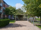 Thumbnail 27 of 29 - a brick walkway with a pergola in the middle of a grassy area