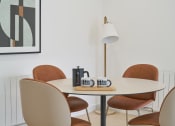 Thumbnail 8 of 29 - a round table with four chairs and a lamp in the corner of a room