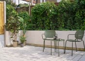 Thumbnail 20 of 29 - a patio with two green chairs and a table