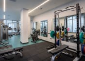 Thumbnail 5 of 18 - a gym with weights and equipment in a building