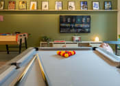 Thumbnail 15 of 35 - a game room with a pool table and a tv