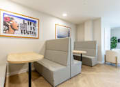 Thumbnail 55 of 65 - A room with a grey sofa and a wooden table.