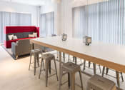 Thumbnail 5 of 16 - a long table with bar stools in a room with a red couch