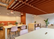 Thumbnail 11 of 35 - a dining area with tables and chairs in a room with orange and white walls