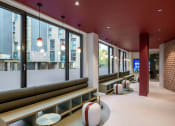 Thumbnail 4 of 20 - a view of the lobby of a hotel with chairs and windows