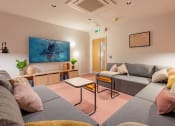 Thumbnail 8 of 35 - a living room with couches and a tv