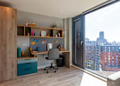 Thumbnail 31 of 36 - A modern home office with a desk, chair, and shelves.