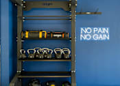 Thumbnail 32 of 36 - a shelf with pairs of boxing gloves and a no pain no gain sign