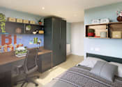 Thumbnail 29 of 33 - A bedroom with a bed, desk, and chair.