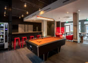 Thumbnail 1 of 18 - a game room with a pool table and a bar