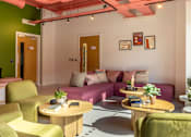 Thumbnail 19 of 36 - a living room with couches and chairs and tables