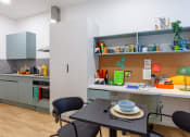 Thumbnail 19 of 35 - a kitchen and dining area with a table and chairs