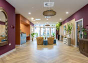 Thumbnail 3 of 35 - A large room with a wooden floor and a hanging light fixture.