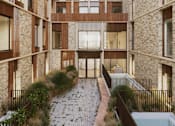 Thumbnail 13 of 26 - A courtyard with a brick pathway and a pool.