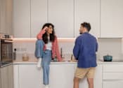 Thumbnail 13 of 54 - A man and a woman are standing in a kitchen.
