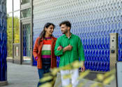 Thumbnail 2 of 54 - Two people walking together on a sidewalk.