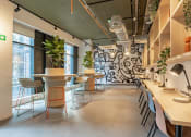 Thumbnail 2 of 35 - a dining room with tables and chairs and a mural on the wall