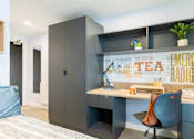 Thumbnail 8 of 35 - A modern bedroom with a bed, desk, and chair.