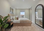 Thumbnail 33 of 38 - A bedroom with a large bed and a view of the city.