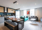 Thumbnail 2 of 18 - a kitchen and living room with a table and chairs