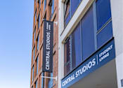 Thumbnail 38 of 41 - A sign for Central Studios Student Living is displayed on a building.