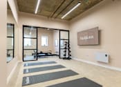 Thumbnail 58 of 65 - A gym with yoga mats and a sign that says "Fit & Knox".