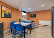 Thumbnail 27 of 35 - A dining room with a table and chairs.