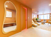 Thumbnail 5 of 65 - A living room with a large mirror on the wall.