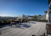 Thumbnail 6 of 18 - a terrace with tables and chairs on a roof top