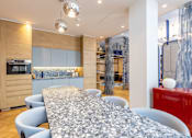 Thumbnail 10 of 41 - A modern dining room with a long table and chairs.