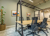 Thumbnail 6 of 65 - A conference room with a long table and chairs.