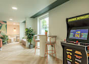 Thumbnail 8 of 25 - A room with a Legends Ultimate pinball machine on a stand.