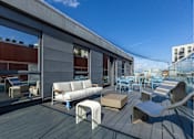 Thumbnail 5 of 41 - A modern outdoor seating area with a wooden deck and white furniture.